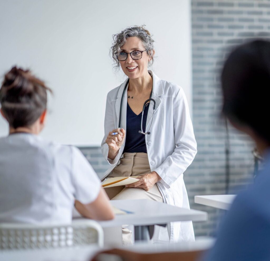 Senior clinician leading an ECMO training session, preparing peers with expert instruction and hands-on readiness.